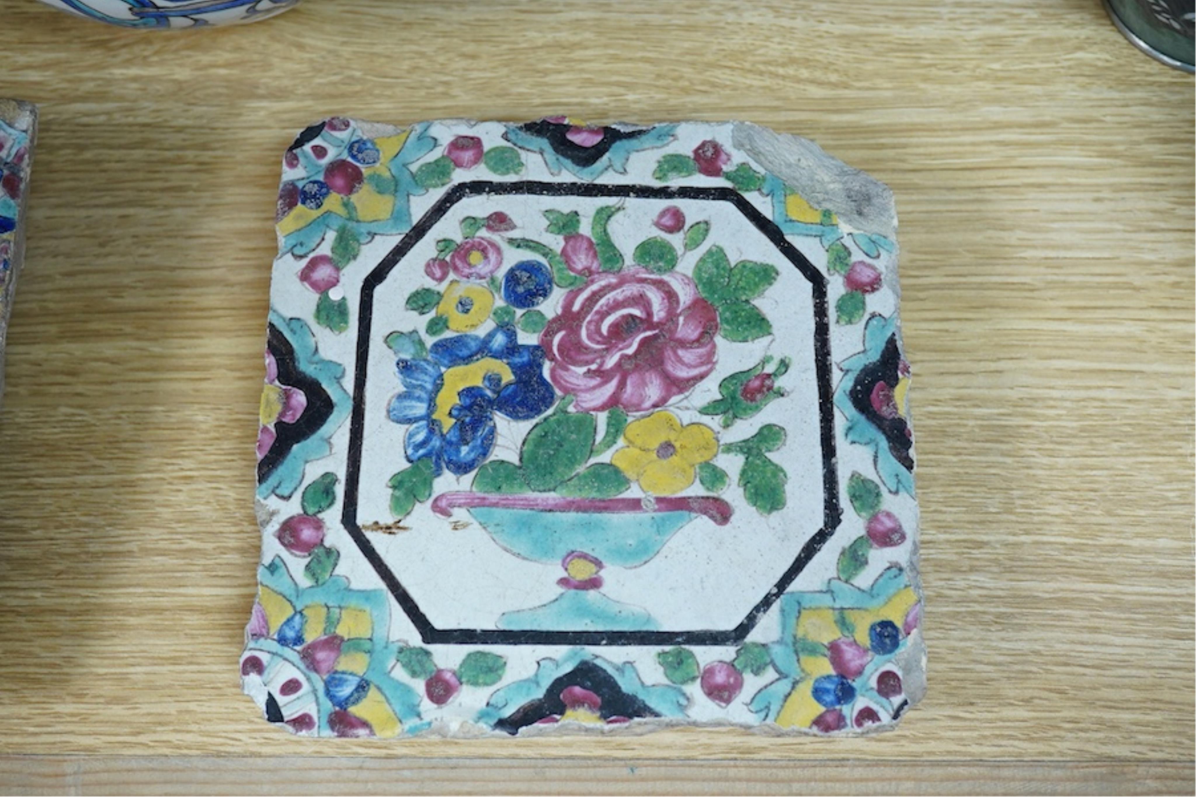 A Persian stoneware vase (reduced) and two floral tiles